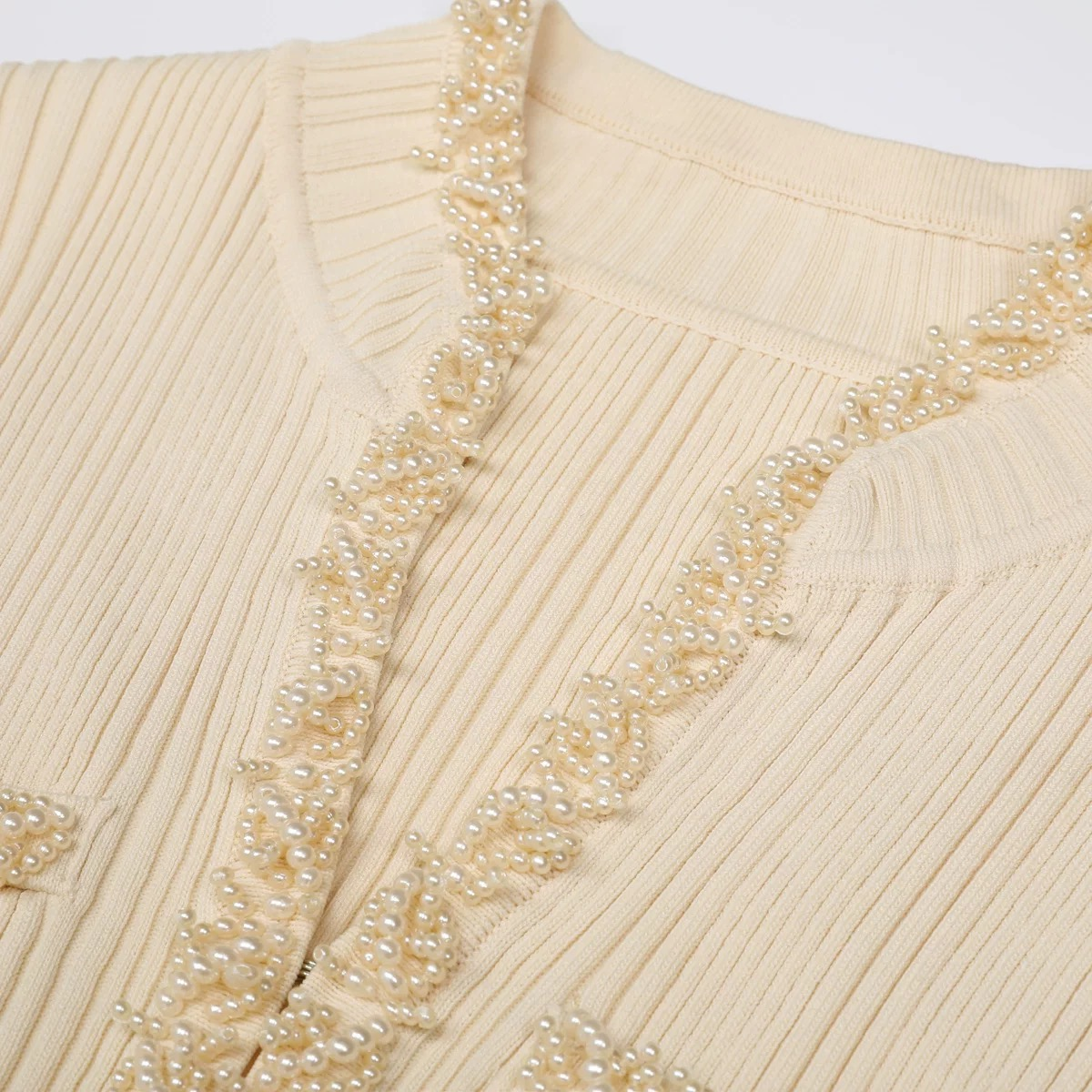 How does the pearl embellishment enhance the overall aesthetic appeal of the mermaid knit dress?